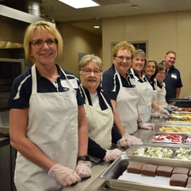 Serving Others PREMIER Employees serving in buffet line